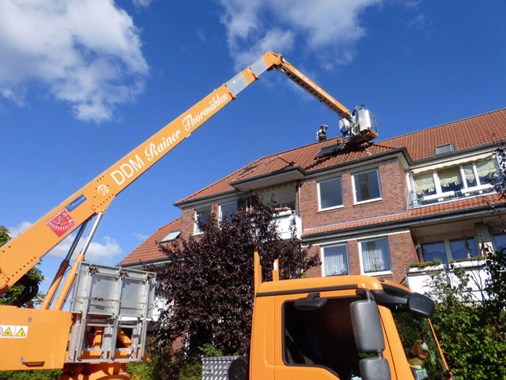Dachdecker bei Dacharbeiten mit Kran – präzise Dachsanierung durch Meisterbetrieb Thormählen.
